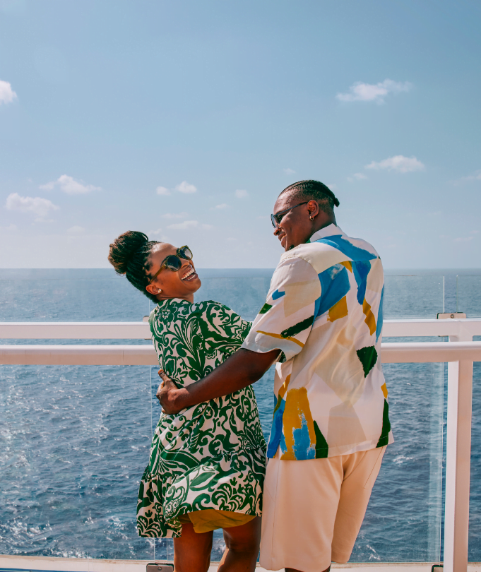 Couple enjoying their Carnival cruise on the deck of the ship.