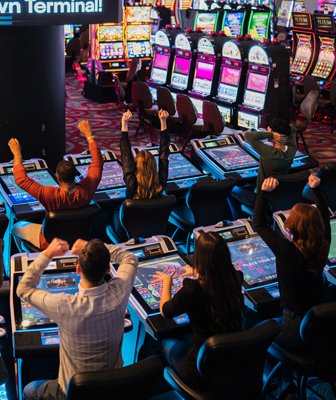 A group of people playing electronic roulette.