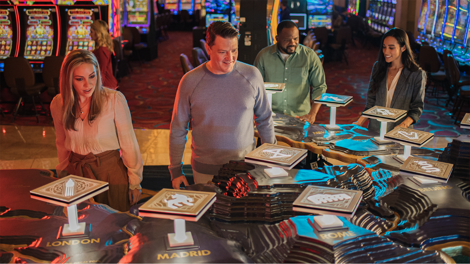 Four people looking at a map of WinStar with various icons for each gaming plaza.